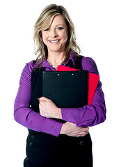 Image showing Corporate woman holding documents tightly