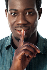 Image showing Silence gesture by a young guy, closeup view