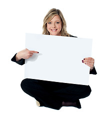 Image showing Professional female executive pointing towards billboard