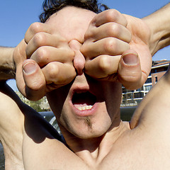 Image showing Man's nose between two robust fists.