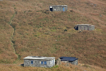 Image showing old stone house with grass on the mountain 