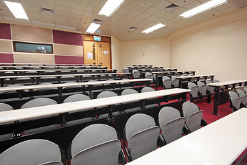 Image showing Empty hall for presentation with grey armchairs 