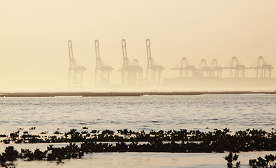 Image showing container cranes on a foggy morning