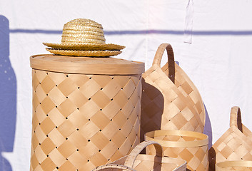 Image showing wicker wooden baskets and hats sold at market fair 