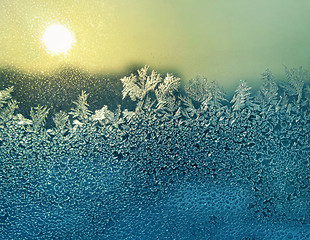 Image showing ice patterns and sun on winter glass