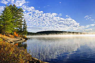 Image showing Autumn lake shore with fog