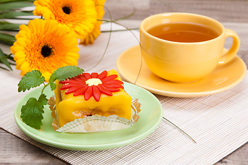 Image showing tea with cake and gerberas flowers