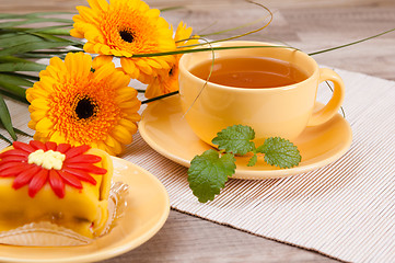 Image showing tea with cake and gerberas flowers