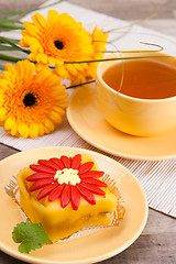 Image showing tea with cake and gerberas flowers