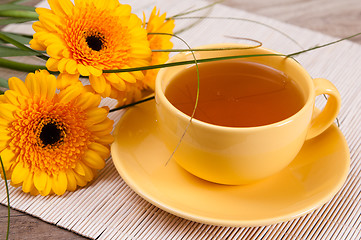 Image showing tea with cake and gerberas flowers