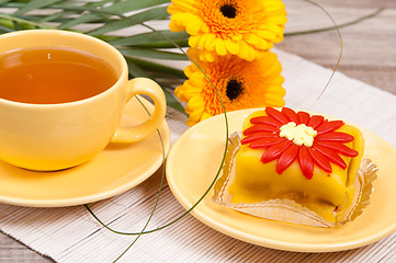 Image showing tea with cake and gerberas flowers