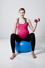 Image showing Pregnant woman exercising with dumbbells