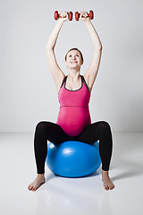 Image showing Pregnant woman exercising with dumbbells