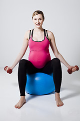 Image showing Pregnant woman exercising with dumbbells