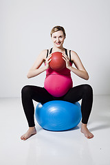 Image showing Pregnant woman exercising with exercise ball