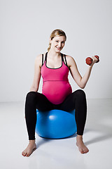 Image showing Pregnant woman exercising with dumbbells