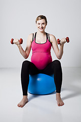 Image showing Pregnant woman exercising with dumbbells