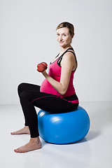 Image showing Pregnant woman exercising with dumbbells