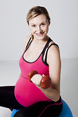 Image showing Pregnant woman exercising with dumbbells