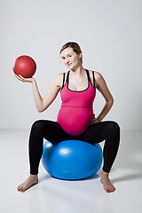 Image showing Pregnant woman exercising with exercise ball