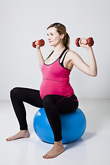 Image showing Pregnant woman exercising with dumbbells