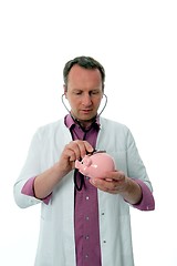Image showing Doctor with piggy bank and stethoscope