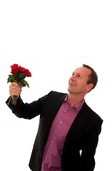 Image showing Man gives a bunch of flowers