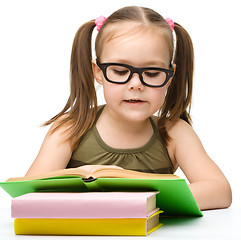 Image showing Cute little girl reading book