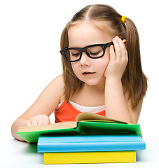 Image showing Cute little girl reading book