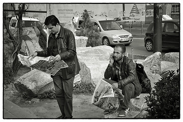 Image showing Two men reading news