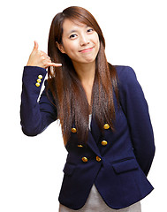 Image showing young asian girl making a call me gesture