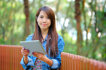 Image showing young asian woman with tablet computer outdoor