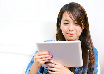 Image showing young asian woman using tablet computer