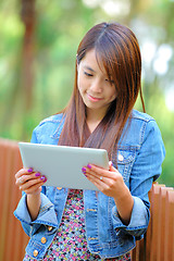 Image showing young asian woman with tablet computer outdoor