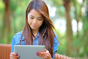 Image showing young asian woman with tablet computer outdoor