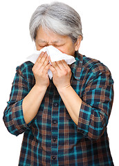 Image showing mature asian woman sneezing