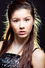 Image showing beautiful  teenager girl with long dark hair on black