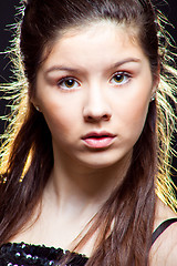 Image showing beautiful  teenager girl with long dark hair on black