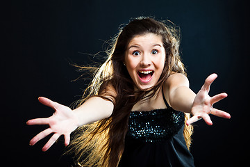 Image showing cute girl with dark long hair shouting on black