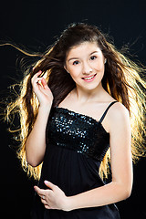 Image showing teenager girl with  beautiful long dark hair  on black