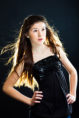 Image showing cute teenager girl with  beautiful long dark hair  on black