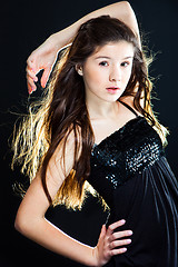 Image showing cute teenager girl with  beautiful long dark hair  on black