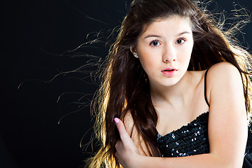 Image showing cute teenager girl with  beautiful long dark hair  on black