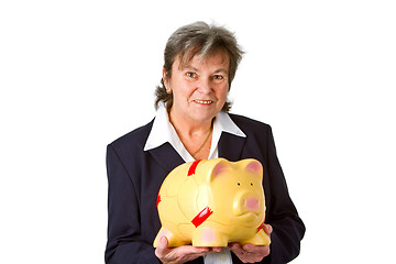 Image showing Female senior with piggy bank 