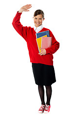 Image showing Full length view of student girl with giving hi5