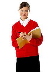 Image showing Caucasian student school girl writing on her notebook