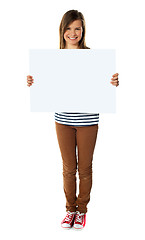 Image showing Smiling girl holding empty white board