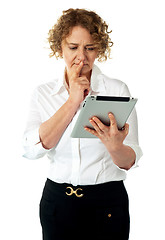 Image showing Businesswoman looking at tablet and thinking deep