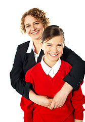 Image showing Teacher embracing her student from back