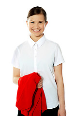 Image showing School girl holding her red sweater and smiling